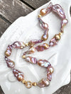 Necklace with pink and gold baroque freshwater pearls on a white dish