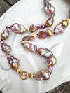 Necklace with pink and gold baroque freshwater pearls on a white dish